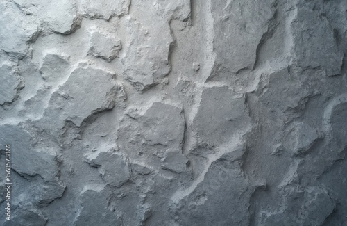 Natural gray granite stone texture. Rough, aged surface with deep crevices, varied color tones, from white to brown, black. Hard, solid material macro detail, abstract pattern. Ideal for
