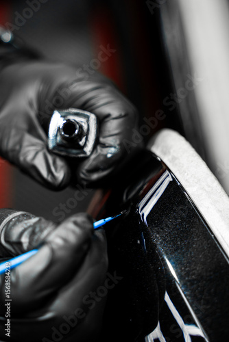 Touch-up detailing targets scratches and rock chips with exact color matching. Touch-up paint applying to car chip using fine micro brush to prevent rust and restores the car original look.