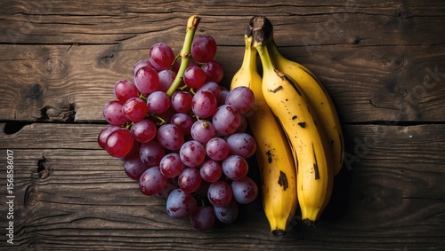Rotten Red Grapes With Two Yellow Bananas on Wooden Texture Background, Empty Space for Text