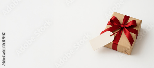 Wallpaper Mural Brown gift box with red ribbon and tag on white background for special occasions. concept of present, celebration, festive gift wrapping, copy space Torontodigital.ca
