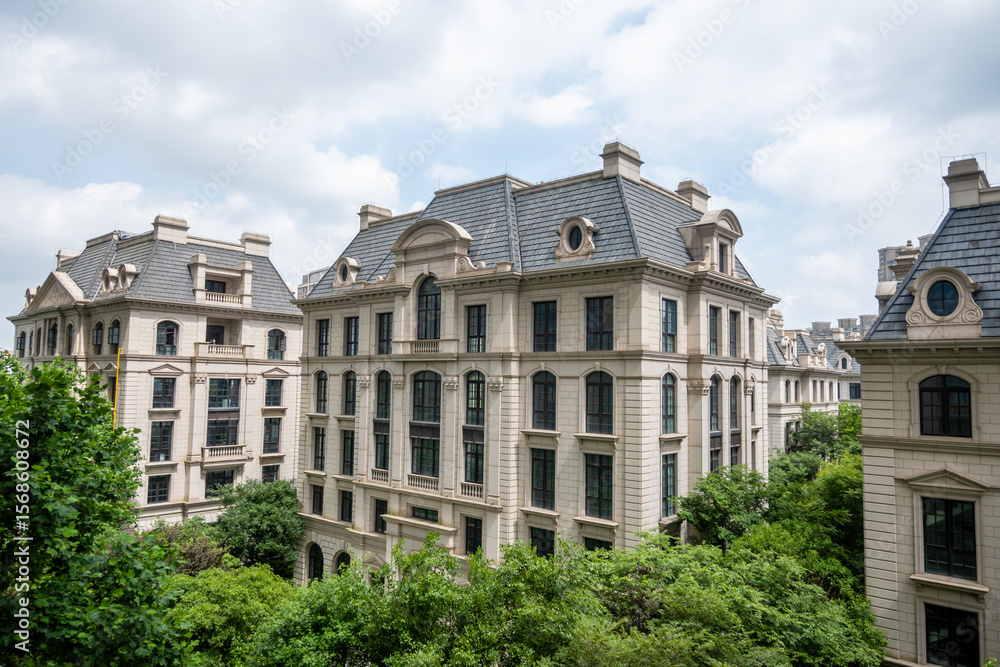 Obraz premium European-style buildings stand in Shanghai, reflecting colonial influences. These structures, a legacy of the treaty port era, blend with modern greenery.