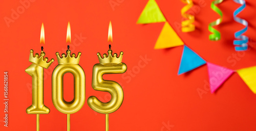 Number 105 candle - Birthday celebration on an orange background with pennants