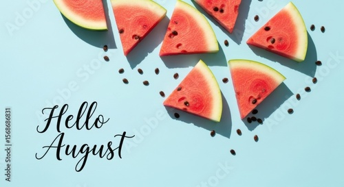 Fresh Watermelon Slices and Seeds on Light Blue Background with Hello August Text.