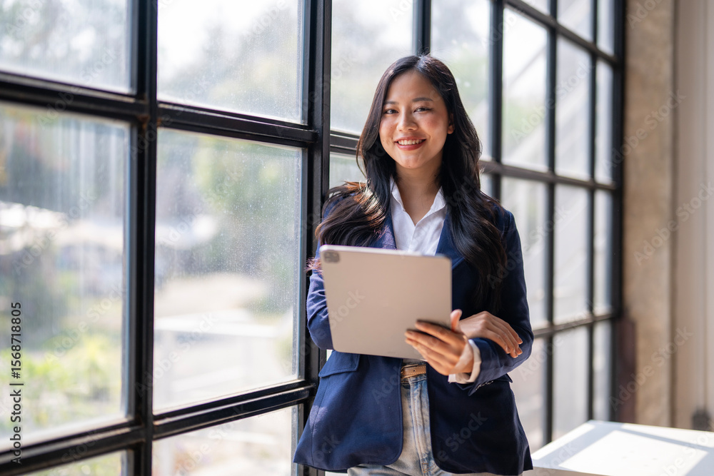 A woman in a business suit holding a tablet A woman in a business suit holding a tablet