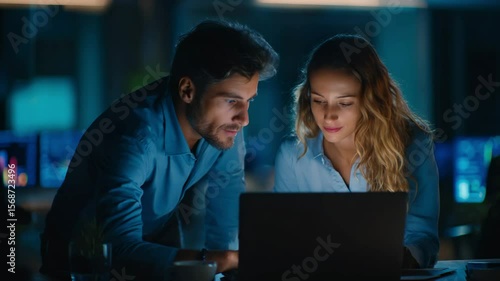 two business people who are having a conversation in front of their laptops