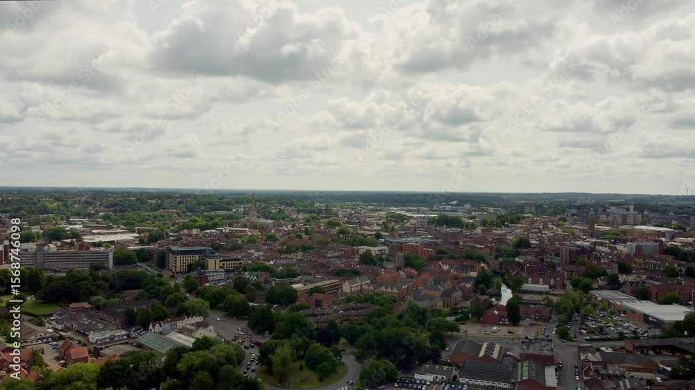 Drone video raising up over Norwich City in Norfolk. Captured on a slightly cloudy day and shows the skyline of commercial buildings, residential homes and flats and greenery mixed in-between. Drone video raising up over Norwich City in Norfolk. Captured on a slightly cloudy day and shows the skyline of commercial buildings, residential homes and flats and greenery mixed in-between.