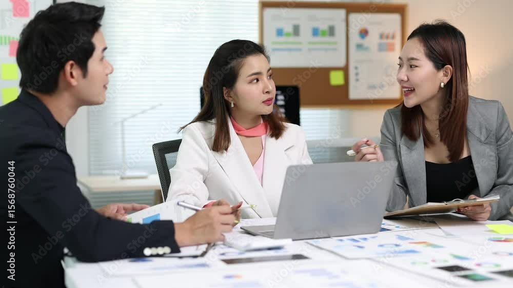 Business colleagues are analyzing financial data on a laptop, discussing strategies and collaborating on a project in a modern office. Business colleagues are analyzing financial data on a laptop, discussing strategies and collaborating on a project in a modern office.