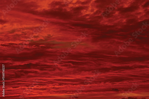 Dramatic red and orange sunset clouds paint a beautiful, fiery sky with intense light at dusk