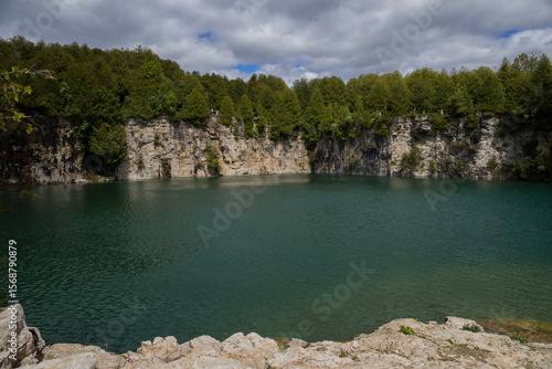 Elora quarry - the place with forest, rocks and amazing blue clear water. Popular place for activity - swimming, hiking and fishing on river. sunny summer day without people. Elora, Ontario, Canada