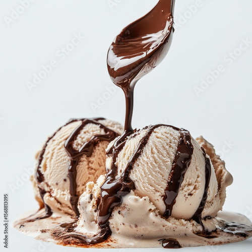Ice cream under a stream of hot chocolate close-up, isolated, on a white background. Illustration for advertising a summer refreshing dessert.