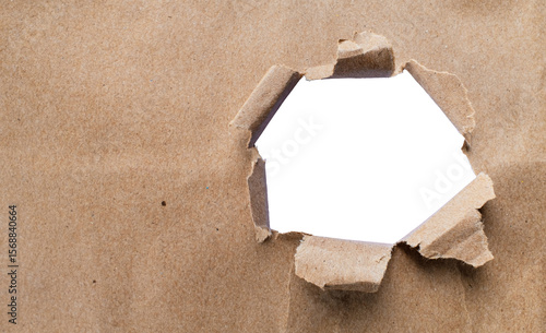 фотографія Torn brown kraft paper and holes on the sides