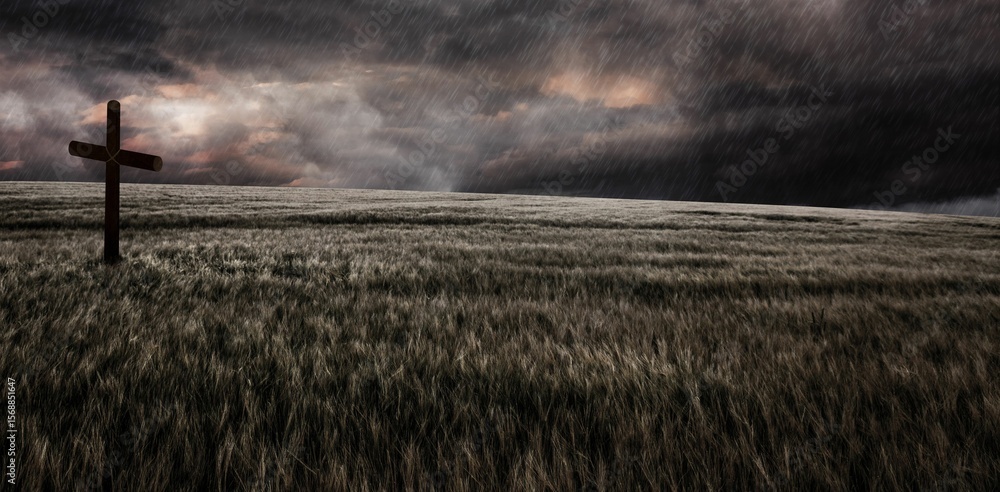 Obraz premium Cross religion symbol shape over sunset sky in a field