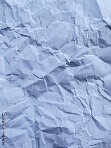 Wrinkled Paper Texture: A close-up shot of a crumpled paper, revealing a intricate textures and creases, it tells a story of wear and tear.