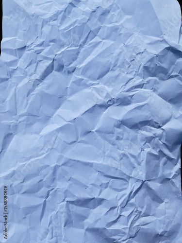 Crumpled Paper Texture: Captivating image featuring a single sheet of intricately folded paper, resulting in a rich display of shadow and form, textures.