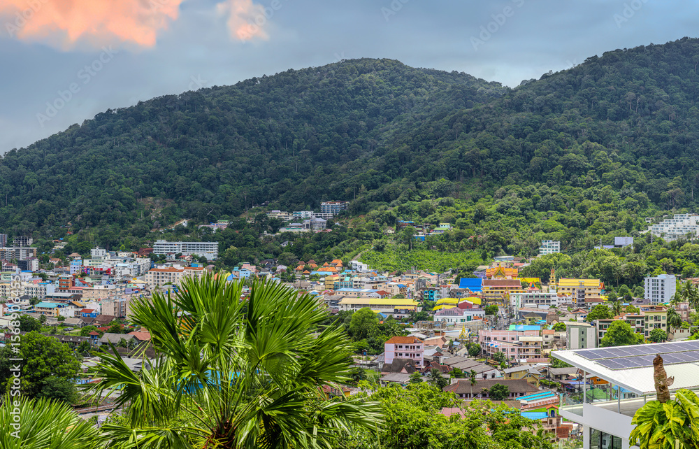 Obraz premium view of Patong and Patong Beach from the mountains colourful skies at Sunset. Patong is a vibrant city full of tourists from all around the world.