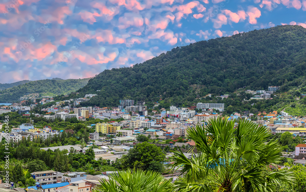 Obraz premium view of Patong and Patong Beach from the mountains colourful skies at Sunset. Patong is a vibrant city full of tourists from all around the world.