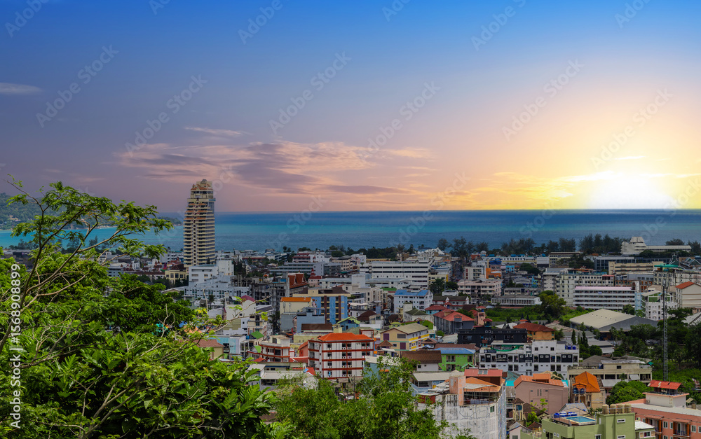 Naklejka premium view of Patong and Patong Beach from the mountains colourful skies at Sunset. Patong is a vibrant city full of tourists from all around the world. 