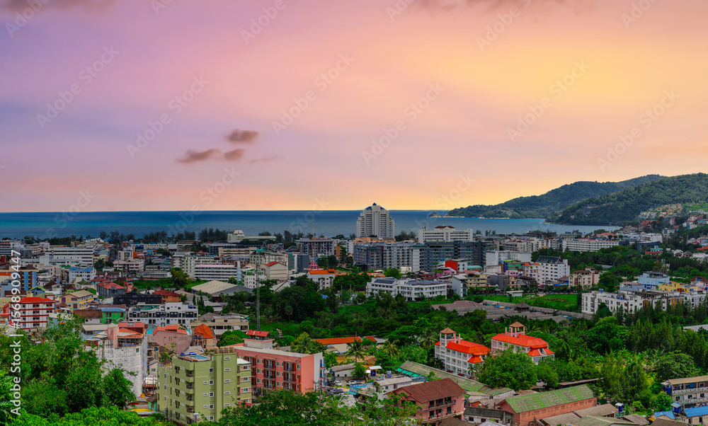 Obraz premium view of Patong and Patong Beach from the mountains colourful skies at Sunset. Patong is a vibrant city full of tourists from all around the world.