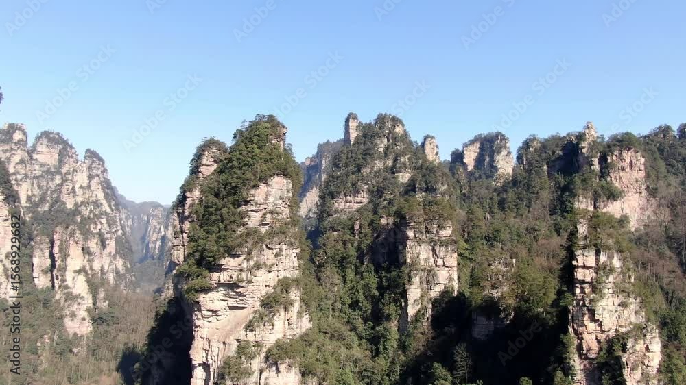 Explore the breathtaking landscapes of Zhangjiajie National Forest Park from above in this stunning aerial shot capturing natural beauty Explore the breathtaking landscapes of Zhangjiajie National Forest Park from above in this stunning aerial shot capturing natural beauty