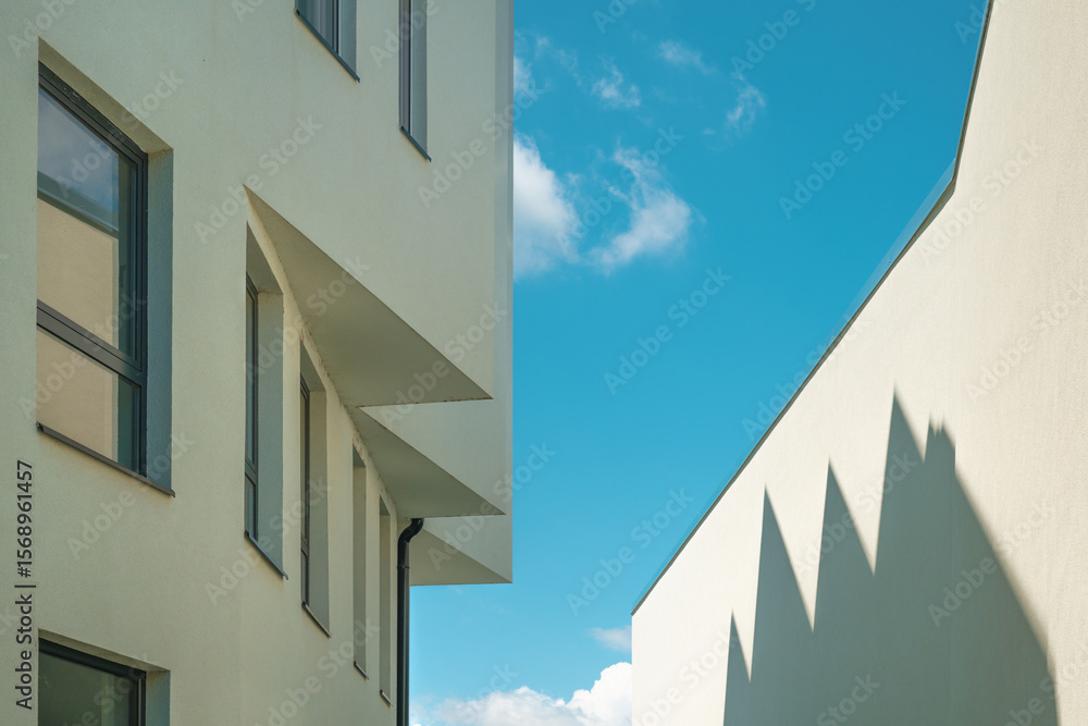 Obraz premium Architectural pattern, modern residential building facade with shadow and light, minimalistic composition