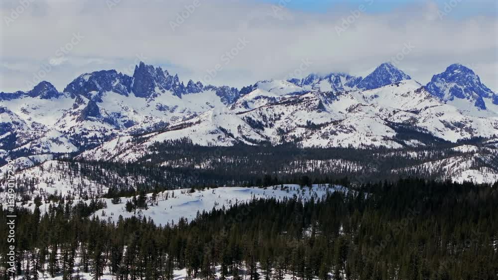 Banner peak Volcanic ridge Minaret Summit Pass Mammoth Mountains vista Parallax winter aerial drone California group jagged towering snow covered peaks sunny blue sky Inyo forest Sierras PCT upwards Banner peak Volcanic ridge Minaret Summit Pass Mammoth Mountains vista Parallax winter aerial drone California group jagged towering snow covered peaks sunny blue sky Inyo forest Sierras PCT upwards