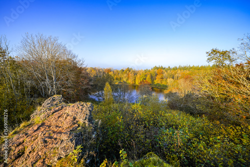View of the Windsborn Kratersee and the surrounding landscape. Nature at the lake in the Eifel region in autumn at the volcanic crater near Bettenfeld.
