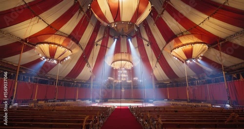 A grand indoor circus tent, with red and white striped canopies, ornate chandeliers, and rows of wooden seats