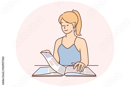 Carefree young woman reading magazine and flipping through page with photos or news about celebrity