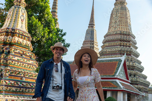 Photography Asian couple tourists visiting Thai temple in Bangkok Thailand on summer holiday