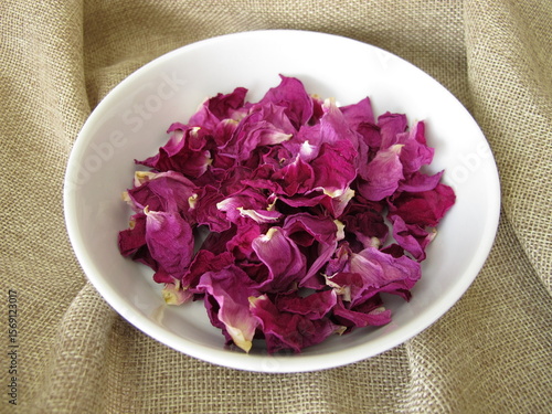 Dried rose petals from the beach rose in a porcelain dish, Rosa rugosa