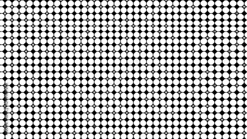 Black and white polka dot pattern with regular circular shapes  