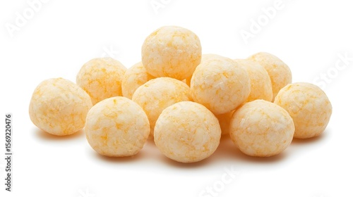 Photograph of a group of yellow cheese balls arranged on a white background.