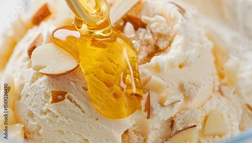 Delicious creamy ice cream topped with sliced almonds and a drizzle of golden honey