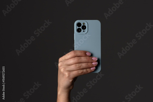 Wallpaper Mural Hand Holding Modern Smartphone with Blue Case Displayed Torontodigital.ca