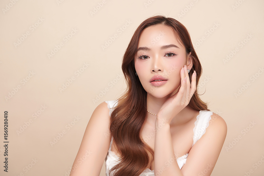 A beautiful young Asian woman with clean, fresh skin against a beige background. Skincare, facial treatment, cosmetology, beauty, and spa. An elegant portrait of an Asian woman. A beautiful young Asian woman with clean, fresh skin against a beige background. Skincare, facial treatment, cosmetology, beauty, and spa. An elegant portrait of an Asian woman.