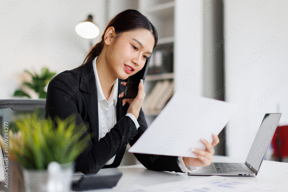 Cheerful young business asian woman freelancer making telephone call share good news about project working in office workplace, business finance concept. Cheerful young business asian woman freelancer making telephone call share good news about project working in office workplace, business finance concept.