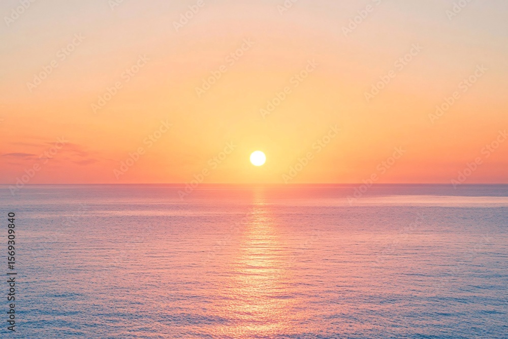 Fototapeta premium Peach-Colored Sky with Sun Setting Over the Ocean
