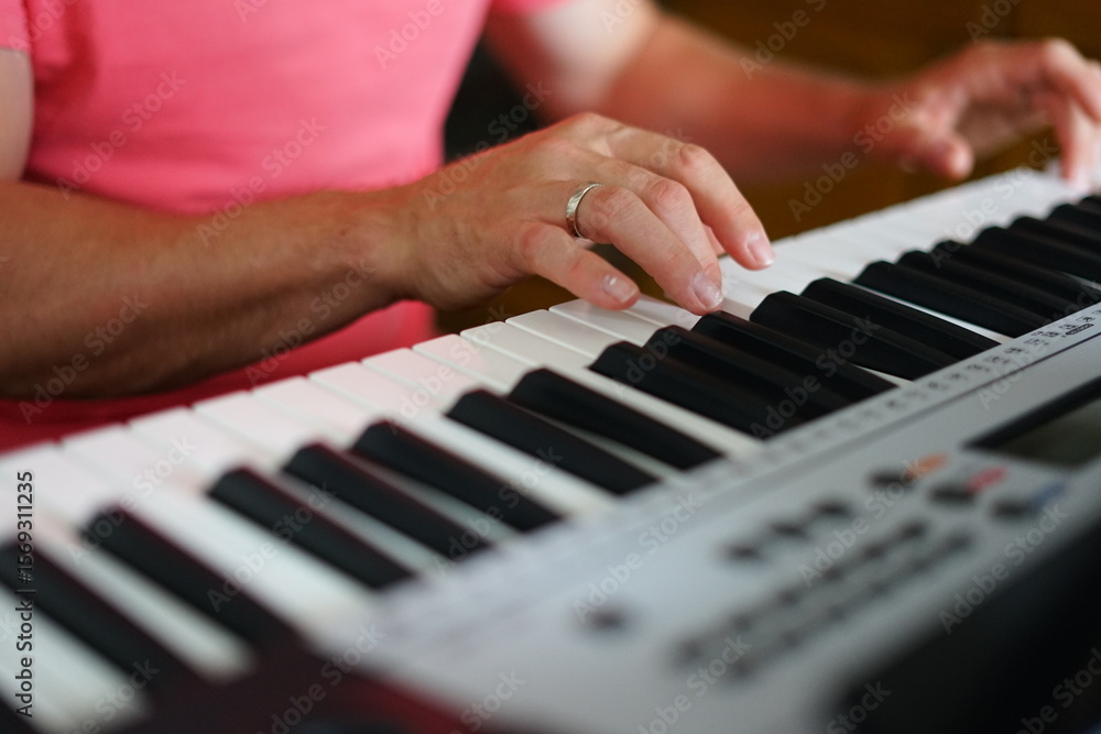 Fototapeta premium Two hands on electronic piano keyboard, music practice