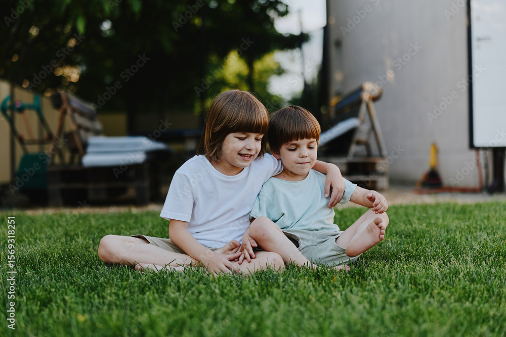 Happy children sitting together on grass, enjoying a sunny day in the park, sharing laughter and playful moments with friends outside. Happy children sitting together on grass, enjoying a sunny day in the park, sharing laughter and playful moments with friends outside.