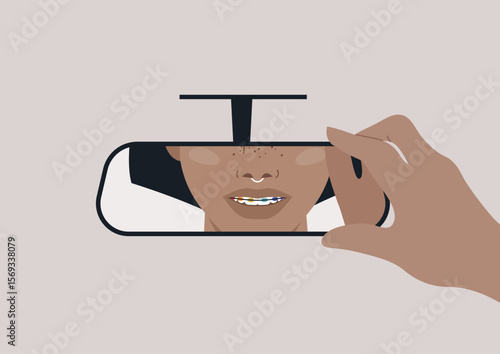 A hand adjusts the rear view mirror, revealing white teeth with colorful braces