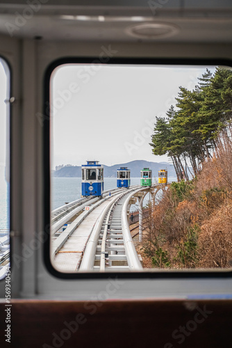 Wallpaper Mural Colourful little trains Busan Haeundae Sky Capsule in Blueline Park in Busan, South Korea  Torontodigital.ca