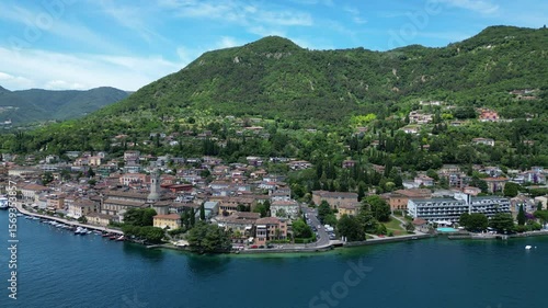 Europe, Italy, Brescia , Garda lake , Salo' drone aerial view of village with church and lake with blue water - Italian Republic from 1943 to 1945 during the reign of Benito Mussolini fascist