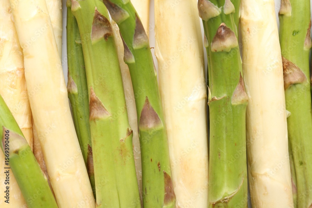 Fototapeta premium Different raw asparagus spears as background, top view