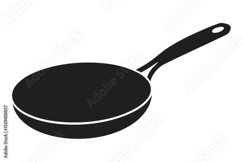 A black skillet with a handle and a hole at the end sits