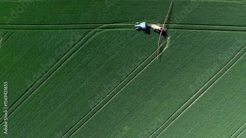 Aerial View of Tractor Spraying Green Field