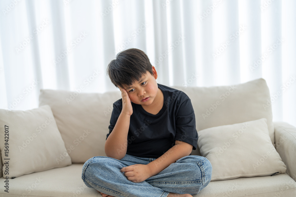 Portrait of sick depressed unhappy child boy touching on head feel suffering head ache pain flu high fever, alzheimer, cancer, stroke, parkinson, disease, cerebral haemorrage, encephalitis, dementia Portrait of sick depressed unhappy child boy touching on head feel suffering head ache pain flu high fever, alzheimer, cancer, stroke, parkinson, disease, cerebral haemorrage, encephalitis, dementia