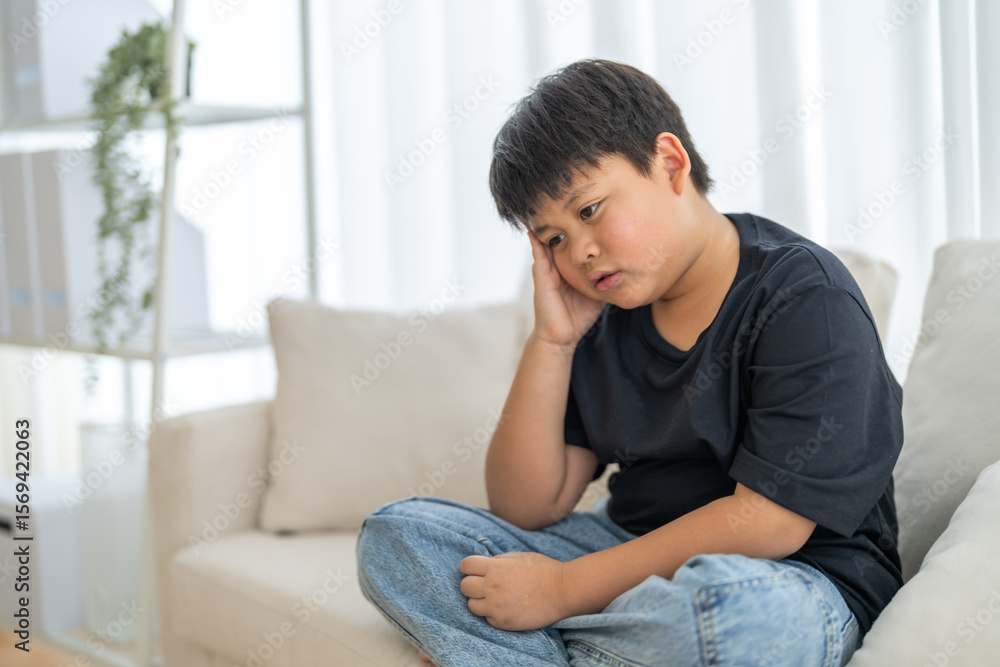 Portrait of sick depressed unhappy child boy touching on head feel suffering head ache pain flu high fever, alzheimer, cancer, stroke, parkinson, disease, cerebral haemorrage, encephalitis, dementia Portrait of sick depressed unhappy child boy touching on head feel suffering head ache pain flu high fever, alzheimer, cancer, stroke, parkinson, disease, cerebral haemorrage, encephalitis, dementia