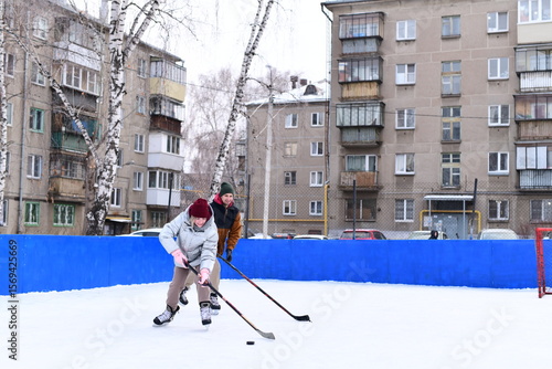 Photography People skate and play ice hockey in the yard