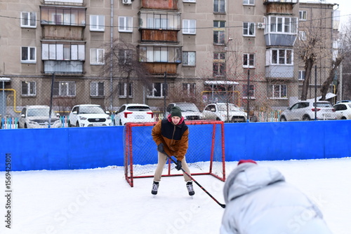 Photography People skate and play ice hockey in the yard