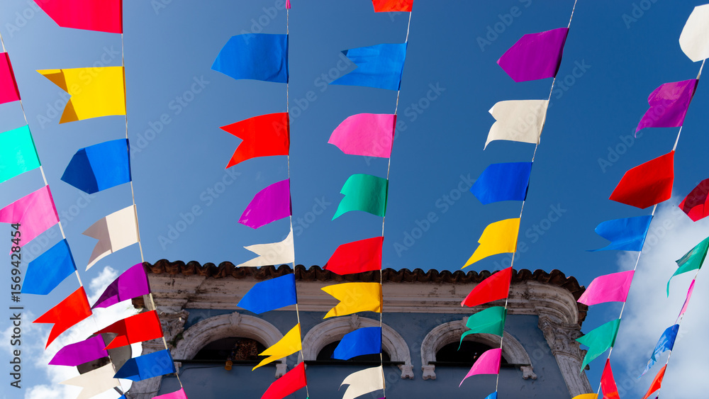 Obraz premium Colorful plastic pennants for decoration against a blue sky.